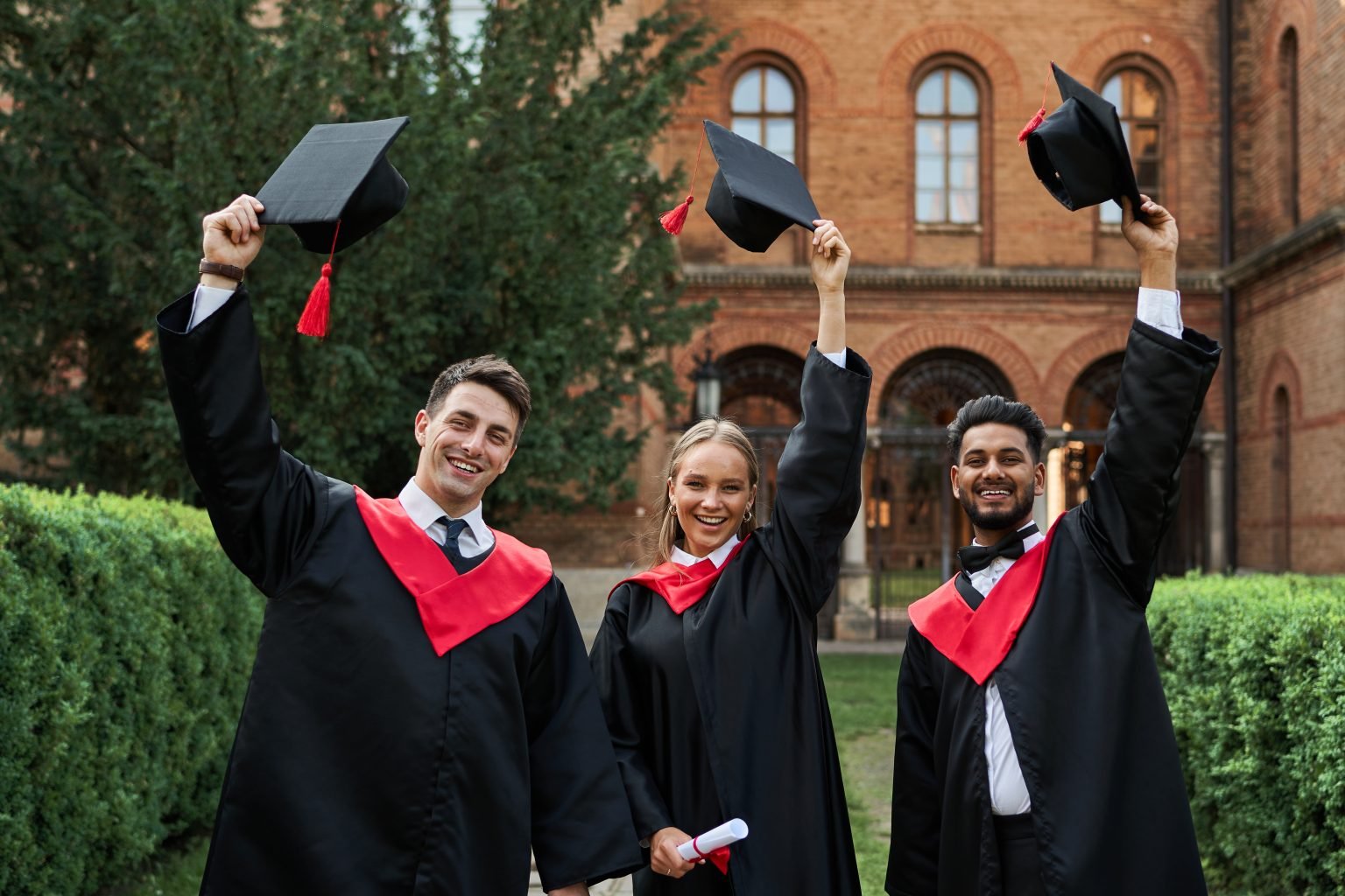 Graduates celebrating together on a university campus